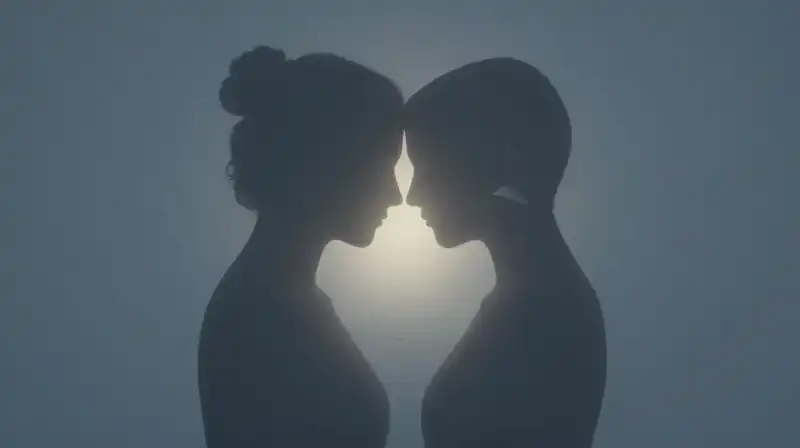 Two silhouettes share a glowing core amidst blue fragments