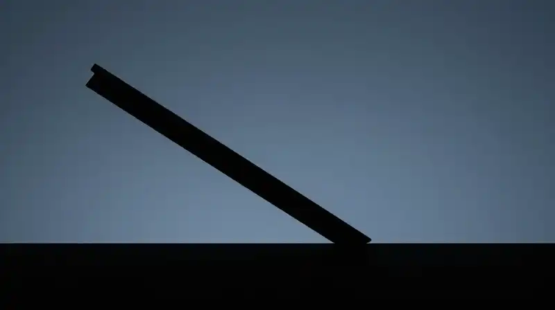 A dark silhouette of a scale tilting unevenly