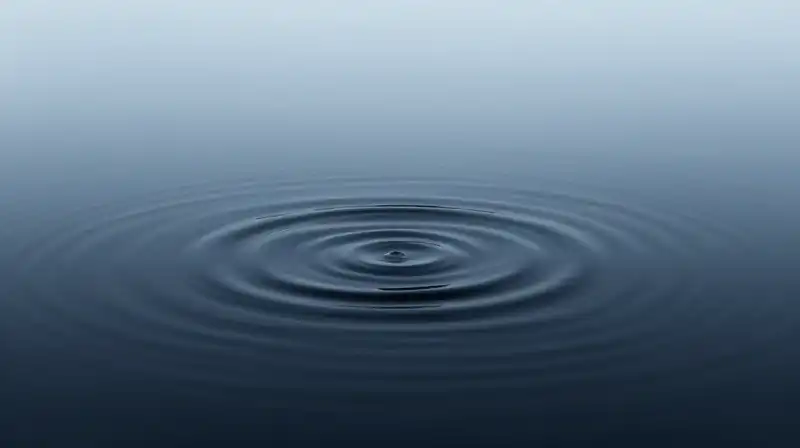 Chaotic dark ripples clash with calm, geometric blue waves