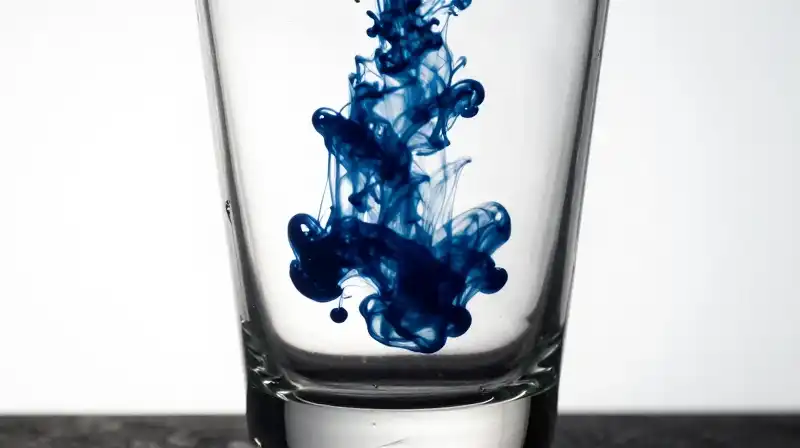 A translucent silhouette swirls inside a dark, empty glass vessel