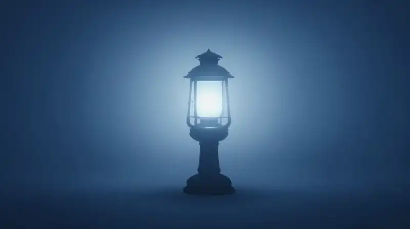 A glowing lantern shines beside a calm, dark silhouette