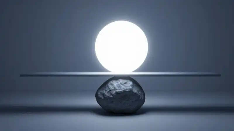 A glowing orb balances against a heavy stone on scales