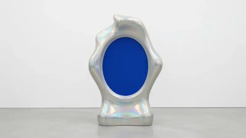 An iridescent sculpture with a solid deep blue core