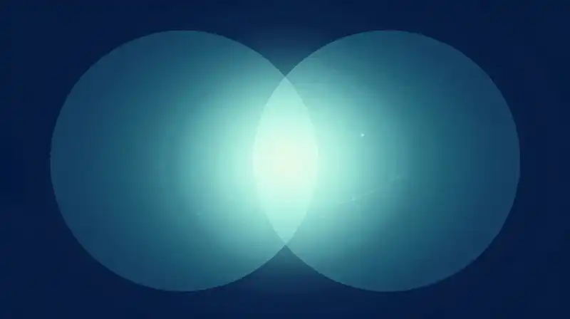 Two overlapping glowing spheres float in a calm blue void