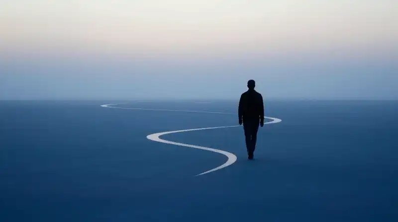 A silhouette walks toward soft light through misty blue paths