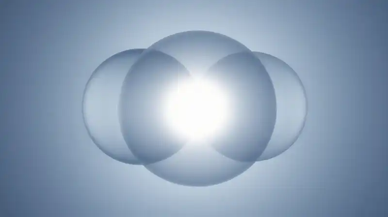 Three glowing, translucent spheres overlap against a calm blue background