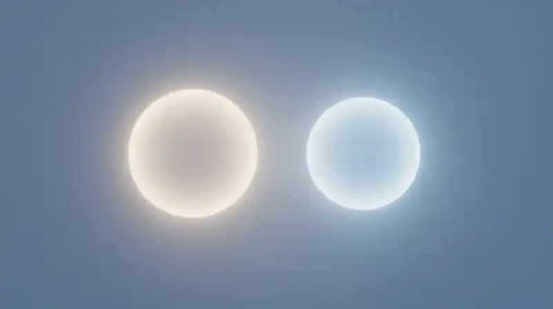 Two glowing spheres drift apart in a calm, blue void