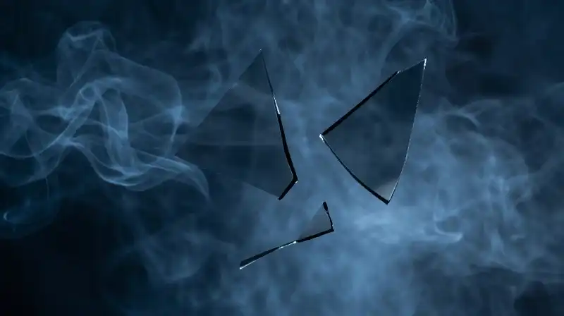 A fragile glass silhouette swirls amidst dark blue smoke