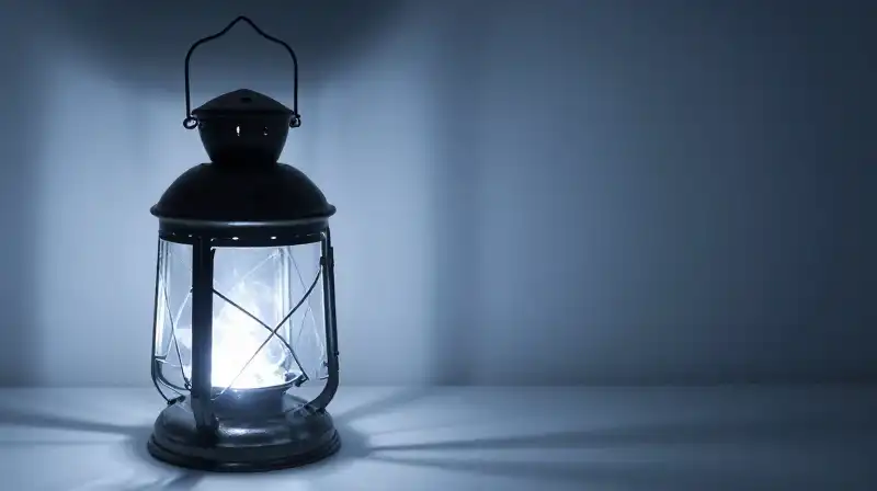 A glowing open lantern contrasts with a hidden shadow