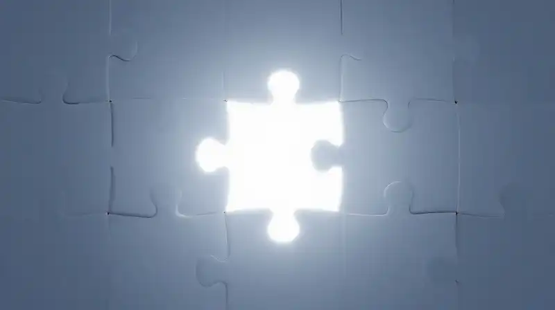 A glowing puzzle piece fits into a complex geometric structure
