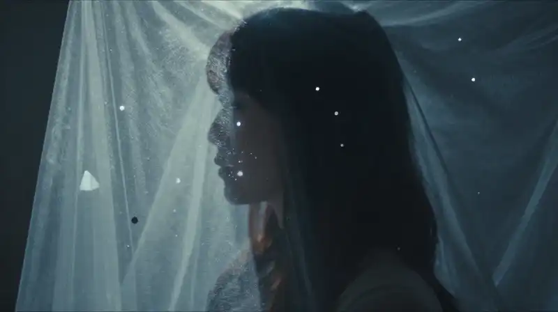 A shimmering silhouette emerges through a veil of glowing particles