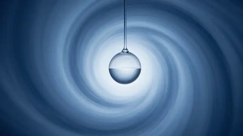 A fragile glass pendulum swings within a blue swirling vortex