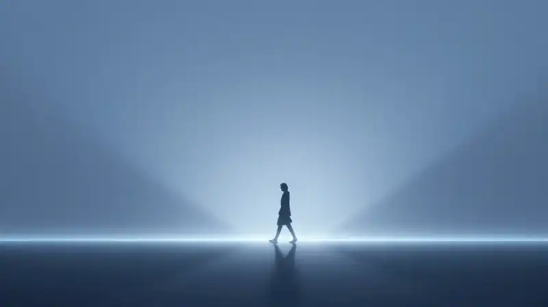 A lone silhouette walks toward light across a misty horizon