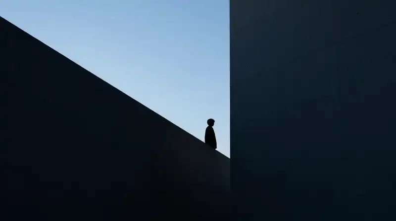Two silhouettes, one large and one small, split geometrically