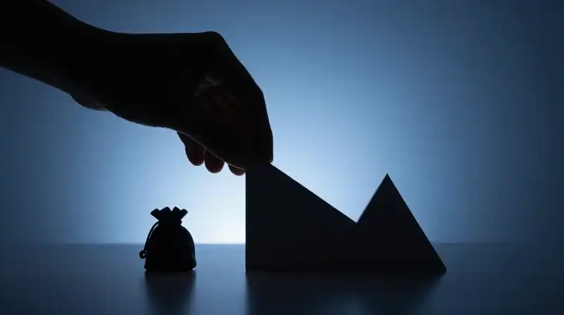 A hand silhouette organizes glowing geometric shapes in blue dimness