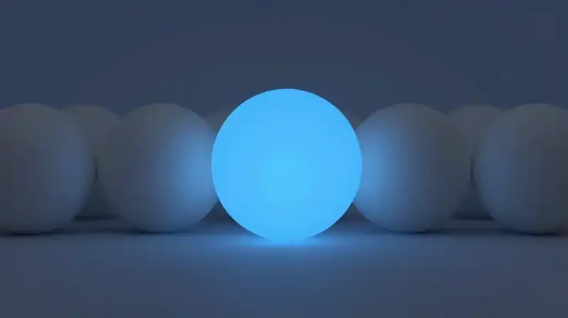 A glowing blue sphere stands out among faded grey ones