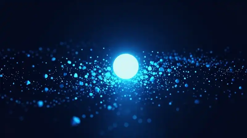 A single bright sphere floats amidst scattered blue geometric particles