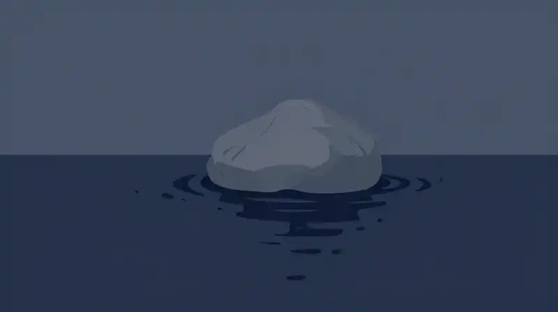 A solitary grey stone sits amidst rippling dark blue water