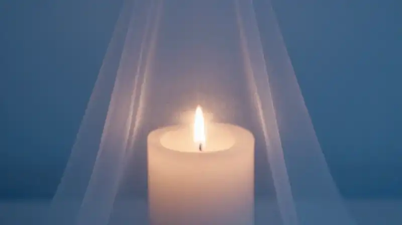 A single candle flame glows behind lifting translucent layers