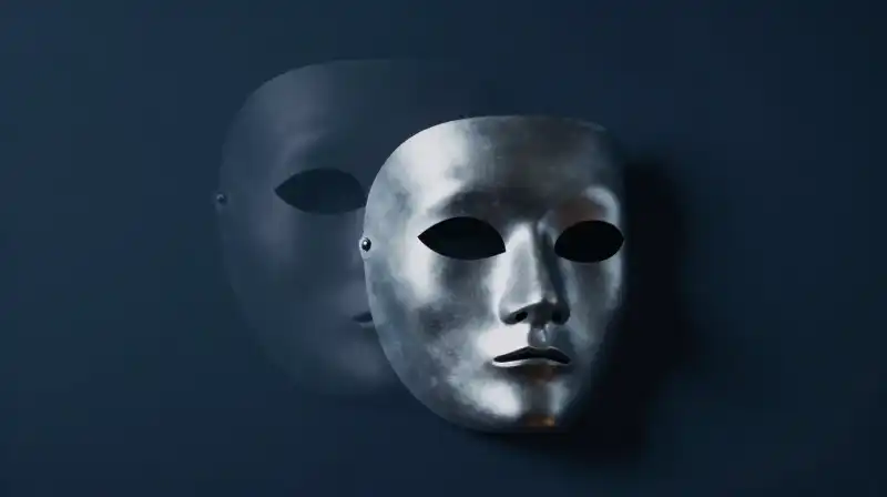 Two translucent silhouettes merge with a silver mask and void