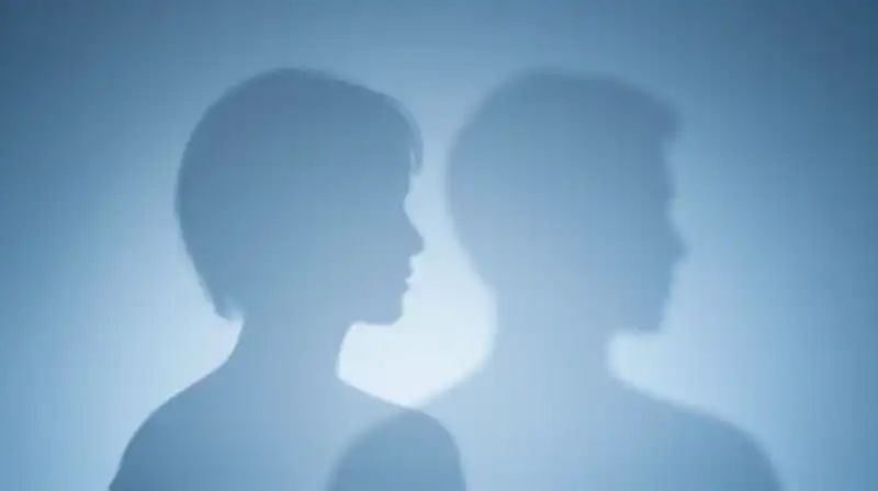 Two overlapping blue silhouettes fade into a minimalist background