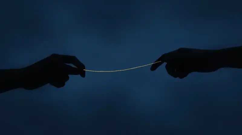 Two silhouettes drift apart through a deep blue void