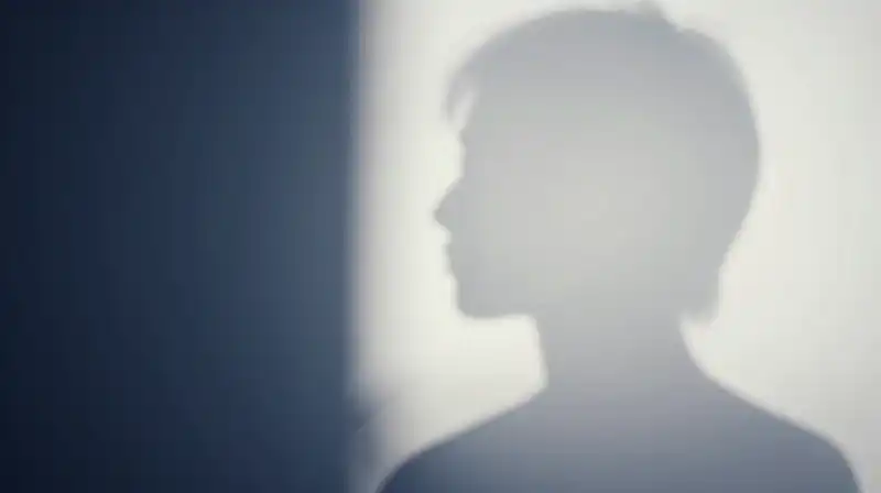 A translucent silhouette split between bright polish and dark fragments