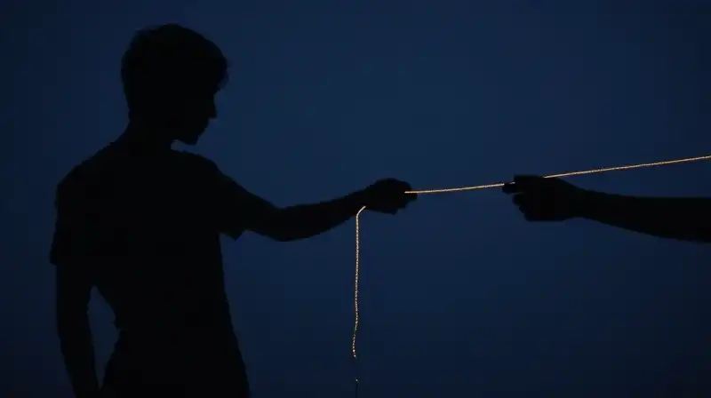 A fragmented silhouette unravels through decaying golden threads