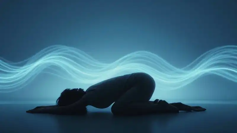 A dark silhouette rests in a fetal pose amidst blue