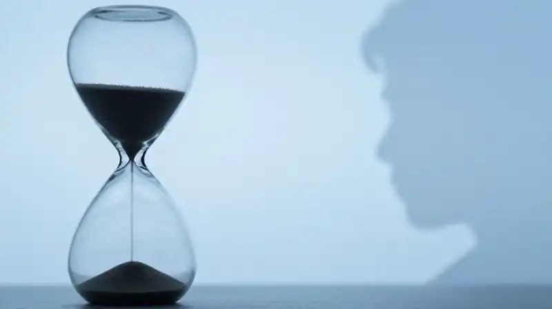 A young profile fades through shifting sands in blue emptiness