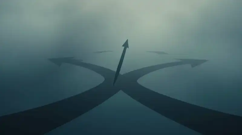 A compass needle points through fog toward many diverging paths