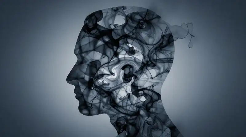 A fragmented human profile swirls with chaotic blue ink patterns
