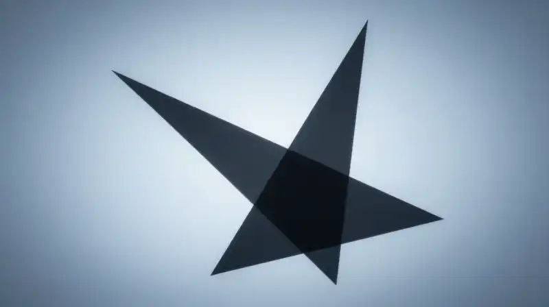 A split shadow meets geometric prisms in a blue haze