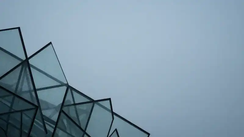 A glass silhouette dissolves into geometric patterns within a void
