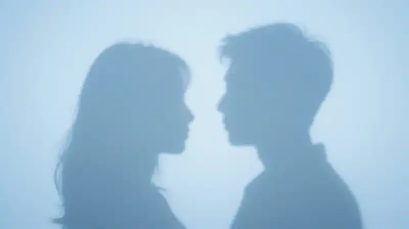 Two overlapping blue silhouettes merge within a fragmented atmosphere