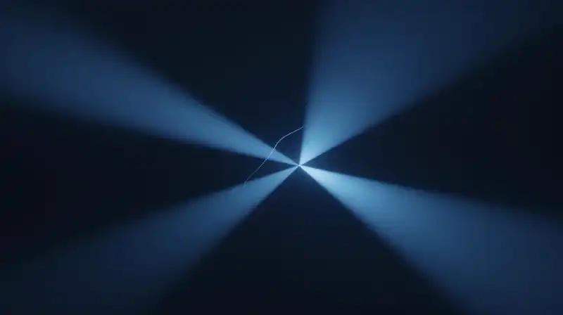 Two paths of blue light split by a glowing thread