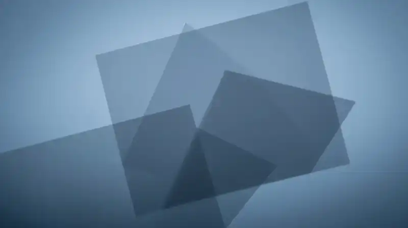 Translucent blue silhouettes overlap among fractured geometric shapes