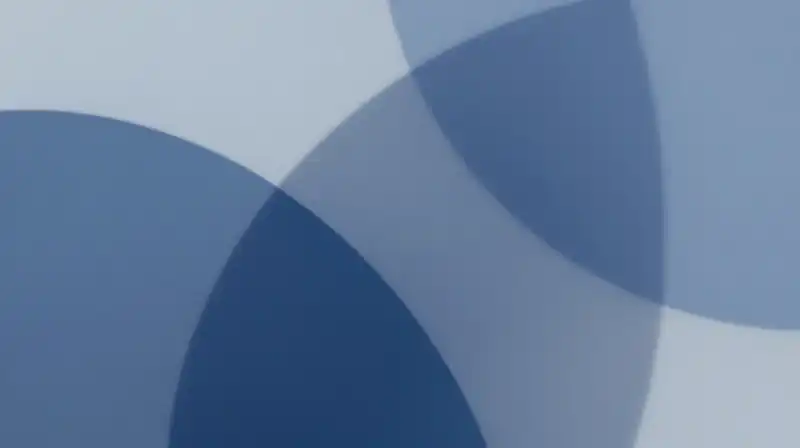 Translucent blue geometric shapes overlap in a calm, minimal setting