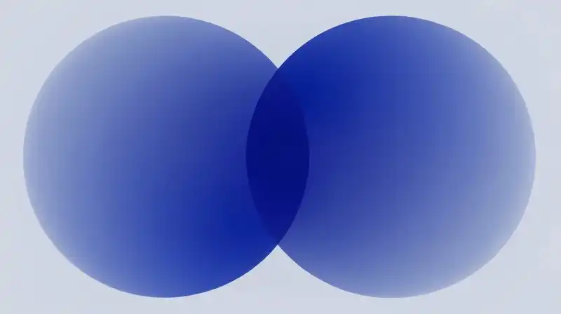 Translucent blue and indigo spheres swirl amidst soft mist