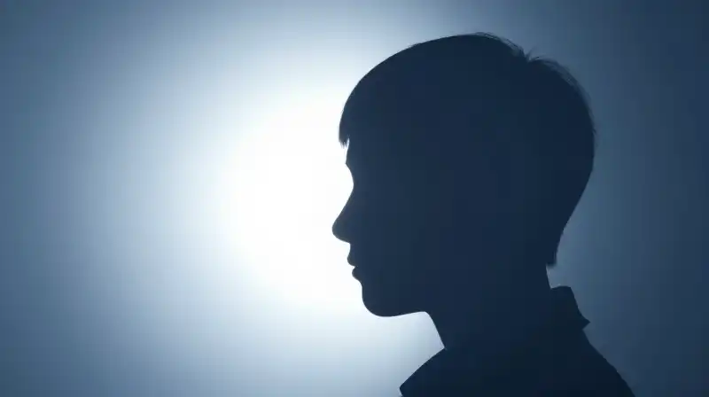 A split silhouette radiates light on one side, shadowed elsewhere
