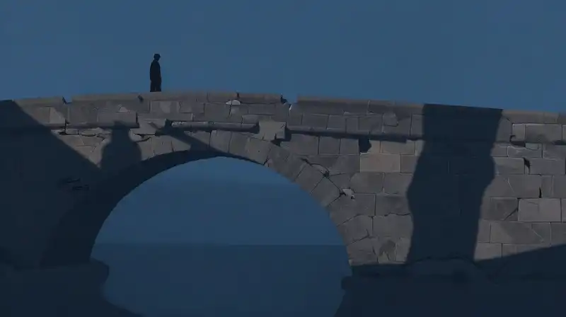 Two silhouettes intertwine over a crumbling stone bridge