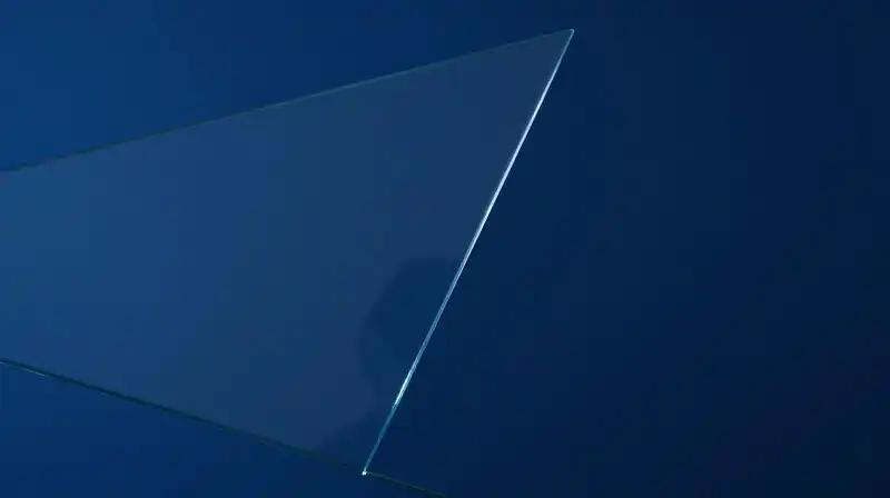 Translucent silhouettes overlap amidst fractured, deep blue mirrored glass