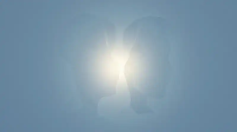 Two glowing, translucent silhouettes merge amidst soft blue fragments