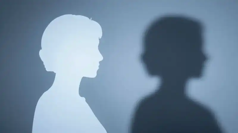 Two side-by-side silhouettes glow softly against a muted blue