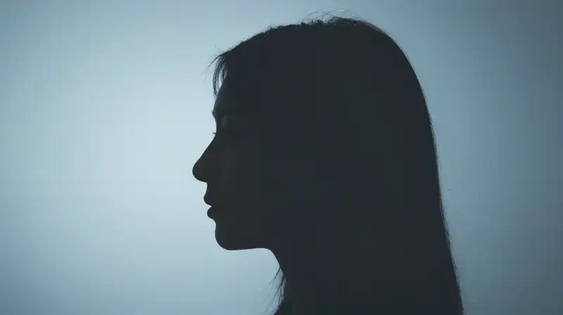 A split profile transitions from radiant light to soft shadow